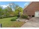 Charming brick home exterior featuring a luscious lawn and mature trees for a serene backyard setting at 2456 Nealwood Ave, Graham, NC 27253