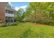 Spacious backyard with mature trees, lawn and patio with screened in porch provides a relaxing view at 2456 Nealwood Ave, Graham, NC 27253