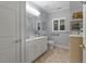 Clean bathroom with a white vanity, matching toilet, framed mirror, and natural light at 2456 Nealwood Ave, Graham, NC 27253