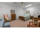 Cozy bedroom featuring carpet floors, rocking chair, nightstands, and a comfortable queen size bed at 2456 Nealwood Ave, Graham, NC 27253
