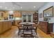 Bright dining area with hardwood floors, a wooden table set, and large windows inviting natural light at 2456 Nealwood Ave, Graham, NC 27253