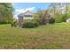 Large, brick two story home sits on a verdant lot with mature landscaping and trees at 2456 Nealwood Ave, Graham, NC 27253