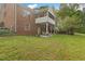 Brick home with a screened-in porch on the 2nd story overlooks a large, well-maintained lawn at 2456 Nealwood Ave, Graham, NC 27253
