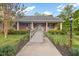 Charming one-story brick home featuring a covered front porch and beautiful landscaping at 2456 Nealwood Ave, Graham, NC 27253