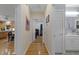 Hallway leading to rooms with hardwood floors, neutral walls, and access to a bathroom and bedroom at 2456 Nealwood Ave, Graham, NC 27253