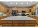 Spacious kitchen with custom wood cabinets, stainless steel appliances, and an island with a white countertop at 2456 Nealwood Ave, Graham, NC 27253