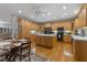 An open kitchen design with hardwood flooring, wooden cabinetry, stainless steel appliances, and a central island at 2456 Nealwood Ave, Graham, NC 27253