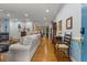 Spacious living room with hardwood floors, multiple seating areas, and kitchen in view at 2456 Nealwood Ave, Graham, NC 27253