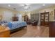 Spacious main bedroom with hardwood floors, ceiling fan, and sitting area with chairs at 2456 Nealwood Ave, Graham, NC 27253