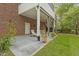 Outdoor patio features neutral furniture, concrete flooring, and planters surrounding manicured grass at 2456 Nealwood Ave, Graham, NC 27253