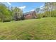 Expansive, well-manicured front lawn with mature landscaping surrounding the brick home at 2456 Nealwood Ave, Graham, NC 27253