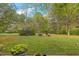 Backyard picnic area with bench seating set in a lush, grassy lawn at 2456 Nealwood Ave, Graham, NC 27253