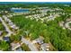 Panoramic aerial view of a neighborhood featuring lush trees, a pond, and well-spaced homes at 249 Mill Creek Dr, Clayton, NC 27527
