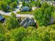 Aerial view showcasing lush green trees surrounding a large home with a well-maintained lawn at 249 Mill Creek Dr, Clayton, NC 27527