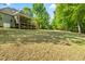 Large backyard features a well-maintained lawn and views of mature trees at 249 Mill Creek Dr, Clayton, NC 27527