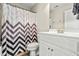 Bathroom featuring a white vanity, patterned shower curtain, mirror and tiled floor at 249 Mill Creek Dr, Clayton, NC 27527