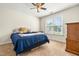 Bedroom with carpet floors features a ceiling fan, window and furniture for storage at 249 Mill Creek Dr, Clayton, NC 27527