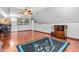 Spacious bonus room with hardwood floors features a Carolina Panthers rug and multiple furniture pieces at 249 Mill Creek Dr, Clayton, NC 27527