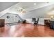 Bonus room features hardwood floors, a ceiling fan, a sofa, and a desk with a chair and dual monitors at 249 Mill Creek Dr, Clayton, NC 27527