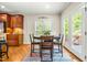 Eat-in kitchen with breakfast table, wooden cabinets and trim, hardwood floors, and french doors at 249 Mill Creek Dr, Clayton, NC 27527