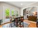 Eat-in kitchen with breakfast table, hardwood floors, french doors, and an arched entryway to living room at 249 Mill Creek Dr, Clayton, NC 27527