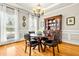 This dining room boasts hardwood floors, a hutch, a chandelier, and bright natural light at 249 Mill Creek Dr, Clayton, NC 27527
