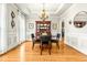 Dining room features hardwood floors, a chandelier, a hutch, and wainscoting for a refined look at 249 Mill Creek Dr, Clayton, NC 27527