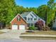 Beautiful two-story home featuring a well-manicured lawn, mature trees, and a two-car garage at 249 Mill Creek Dr, Clayton, NC 27527