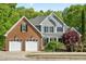 Charming two-story home with a brick and vinyl exterior, two-car garage, and manicured landscaping at 249 Mill Creek Dr, Clayton, NC 27527