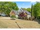 Spacious front yard with a two-story home, mature landscaping, and a driveway leading to the garage at 249 Mill Creek Dr, Clayton, NC 27527