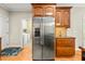 Spacious kitchen boasts stainless steel refrigerator, wooden cabinets, and hardwood floors at 249 Mill Creek Dr, Clayton, NC 27527