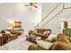 Spacious living room with vaulted ceilings, a staircase, and comfortable seating arrangements at 249 Mill Creek Dr, Clayton, NC 27527