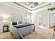 Cozy main bedroom features tray ceiling, fan, ensuite bathroom, and plush carpet at 249 Mill Creek Dr, Clayton, NC 27527