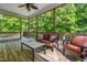 Charming screened porch with natural lighting, ceiling fan, and wooded views at 249 Mill Creek Dr, Clayton, NC 27527