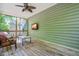 Relaxing screened porch with wood flooring, a mounted TV, and natural lighting at 249 Mill Creek Dr, Clayton, NC 27527