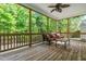Inviting screened porch with wooded views, ceiling fan, and outdoor seating at 249 Mill Creek Dr, Clayton, NC 27527