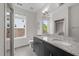 Bathroom with double sinks, granite countertop, and a walk-in shower at 256 William Drummond Way, Raleigh, NC 27604