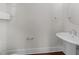 Modern half-bathroom featuring hardwood floors, updated fixtures, and a pedestal sink at 256 William Drummond Way, Raleigh, NC 27604