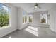 Bedroom featuring a ceiling fan, carpeted floors, and natural light from multiple windows at 256 William Drummond Way, Raleigh, NC 27604