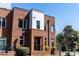 Modern brick exterior with contemporary design elements, lush landscaping, and outdoor seating at 256 William Drummond Way, Raleigh, NC 27604