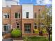 Charming townhome featuring brick accents, a covered front porch, and well-manicured landscaping at 256 William Drummond Way, Raleigh, NC 27604