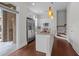 Modern kitchen featuring white cabinets, stainless steel appliances, and a granite-topped island at 256 William Drummond Way, Raleigh, NC 27604