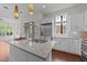 Bright kitchen with white cabinets, stainless steel appliances, and a large center island at 256 William Drummond Way, Raleigh, NC 27604