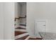 Staircase with hardwood steps and white risers, complemented by a wooden handrail at 256 William Drummond Way, Raleigh, NC 27604