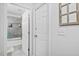 A view from a hallway into the bathroom with a clear shower door and full bathtub at 2801 Dearborn Dr # A, Durham, NC 27704