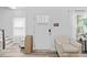 Inviting entryway featuring a white door, modern chair, and bright natural light at 2801 Dearborn Dr # A, Durham, NC 27704