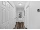 Well-lit hallway featuring hardwood floors, and several doors including one that leads to a shower at 2801 Dearborn Dr # A, Durham, NC 27704