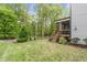Lush backyard featuring a screened porch, a manicured lawn, mature trees, and beautiful landscaping at 2812 Lemnos Dr, Apex, NC 27502
