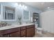 Well-lit bathroom with double vanity, stylish mirrors, shelving, and a shower with a white curtain at 2812 Lemnos Dr, Apex, NC 27502