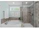 Spa-like bathroom with soaking tub, tiled shower, and tranquil ambiance at 2812 Lemnos Dr, Apex, NC 27502